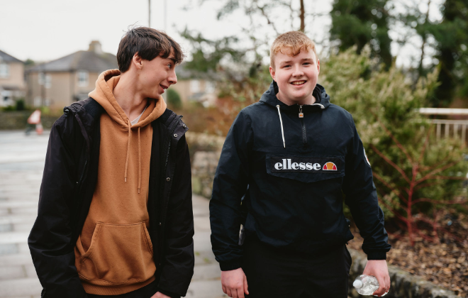 Two boys walking outside